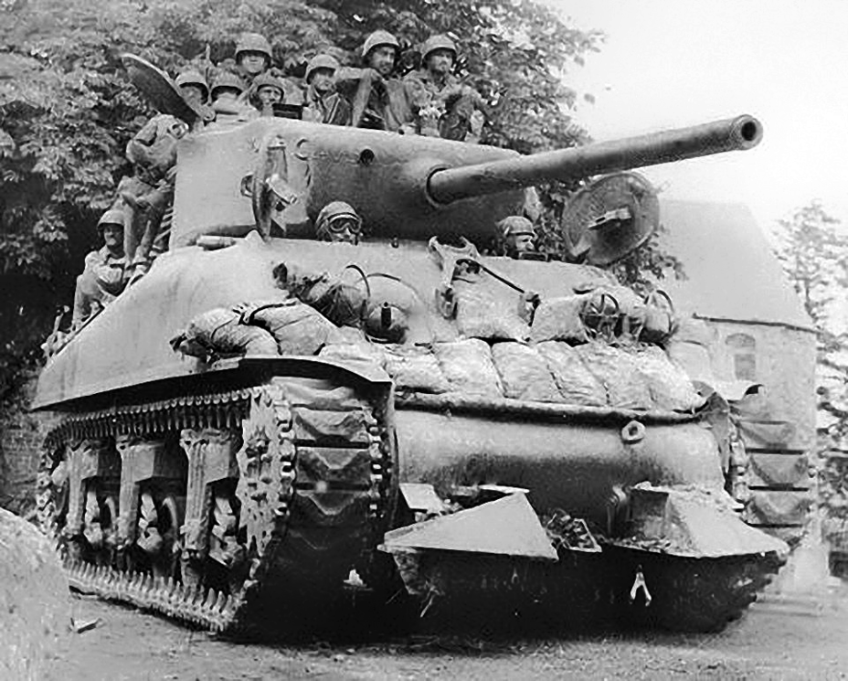 ​An M4A1(76)W tank with infantry riders, who offered much more reliable protection against Panzerfausts than the sandbags - The Tank's Hidden Foe | Warspot.net