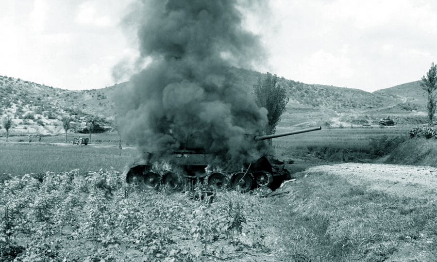 ​A scene from the Korean War. A T-34-85 burns, another one can be seen to the left in the background, with a Sherman tank in the background to the right - A Tank from a Former Ally | Warspot.net