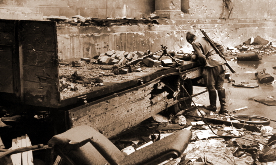 ​Red Army soldier looking at Faustpatrones that lie in a tipper in backyard of a Reich Chancellery in Berlin - Panzerfäust almighty | Warspot.net