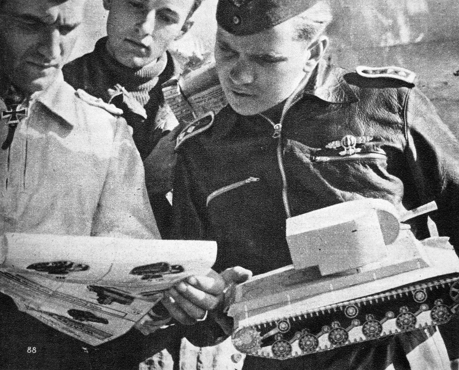 ​Both land and air forces used these models. Here, Hans-Ulrich Rudel (white uniform) is examining an identification chart and model - Weaponized Carboard | Warspot.net