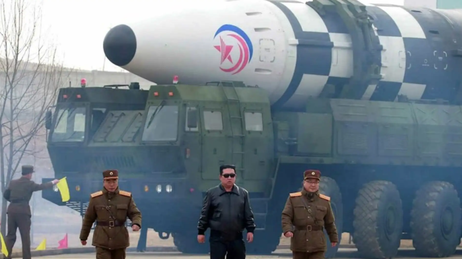 ​North Korean leader Kim Jong Un, in the black leather jacket and sunglasses at center, walks in front of a Hwasongpho-17 The Korean Central News Agency - North Korea confirms test-firing of biggest ICBM | Warspot.net
